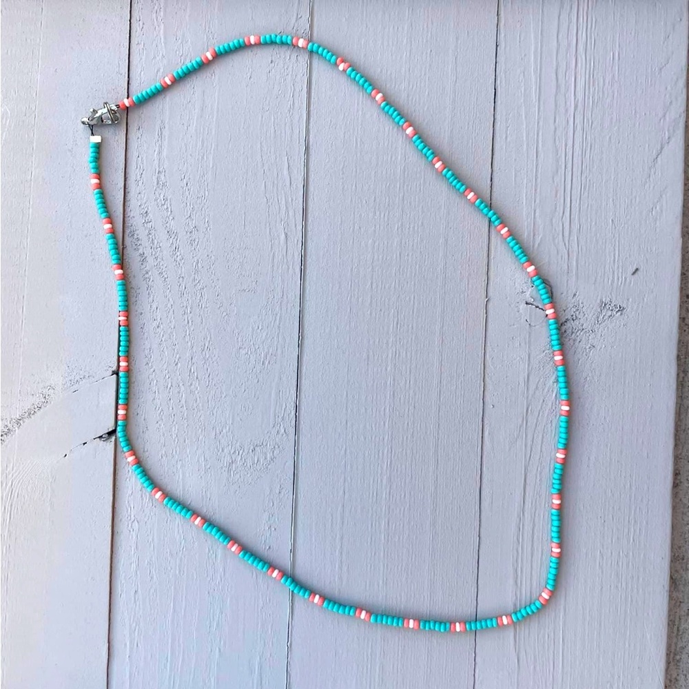 Different kinds and colors of handmade beaded necklaces.